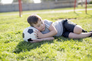 Naklejka premium Young caucassian soccer player football