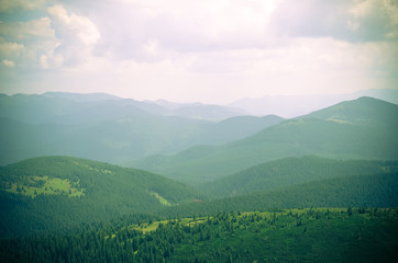 Obraz premium Summer landscape in mountains and the dark blue sky with clouds