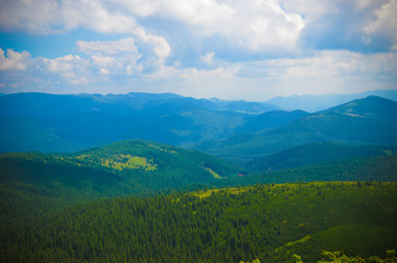 Summer landscape in mountains and the dark blue sky with clouds