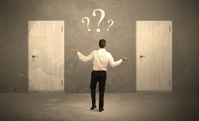Businessman standing in front of doors