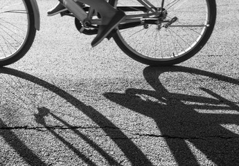 Fototapeta na wymiar Black and white a bicycle against shadow on the street