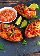 hot baked sweet potato stuffed with yellow, red pepper, chicken, cheese, herbs and salsa. selected focus