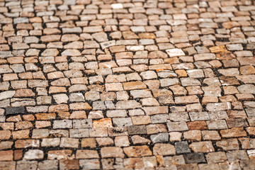 Urban road is paved with blocks of stone, cobblestone walkway, s