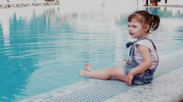 Little girl in the blue pool