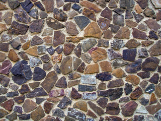 Mosaic wall lined with multi-colored natural stones