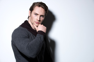 Portrait of sexy young man with hand near face.