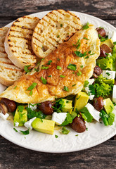 Mushroom, Feta Cheese egg Omelette witch Avocado, vegetables, lettuce, herbs and grilled bread.