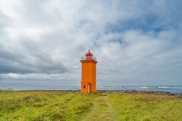 Lighthouse at seashore of Iceland, summer time