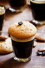 Black coffee and almond biscuits, vintage wooden background, sel