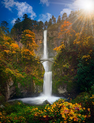 Multnomah Falls in Autumn foliage colors with shining sun