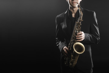 Fototapeta na wymiar Saxophonist Man Saxophone Player with sax alto