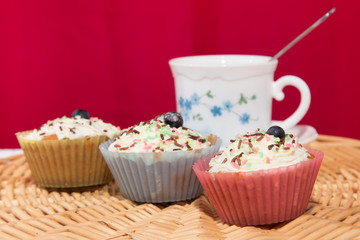 Cup with tea on table with cupcakes. selective focus
