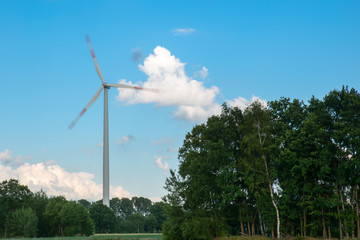 Fototapeta na wymiar Modern windmill / Modern wind turbine in the field