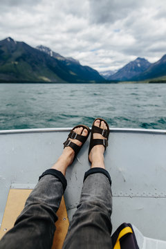 legs, feet and sandals on boat, Lake McDonald, Glacier National Park, Montana, Canada, United States of America , close up