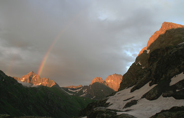 colorful Rainbow in the mountain after rain and stormy clouds