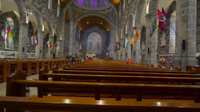 Inside look of the Gothic Church in Ireland with lots of visitors inside in Ireland