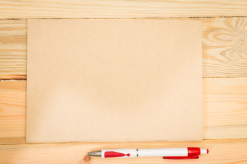 Obraz premium notebook and black pen with wooden background