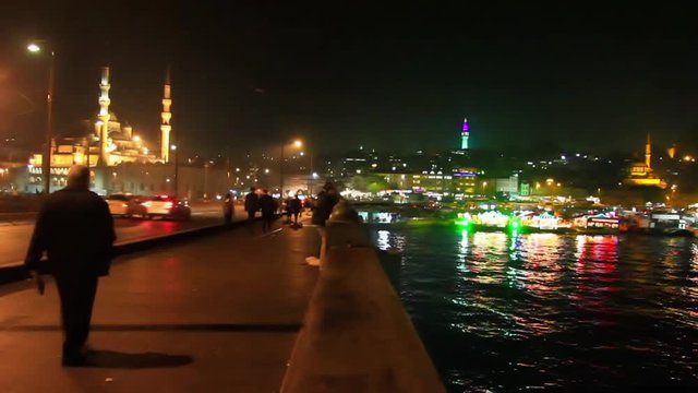Eminonu region looking to Yeni Mosque and Beyazit Tower in Istanbul. Night on the bridge
