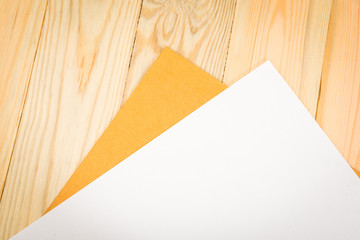 Blank paper and envelope on wooden background