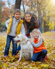 Kid and dog in autumn park