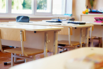 Interior of classroom with empty chairs and desks
