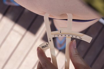 Woman measuring body contouring