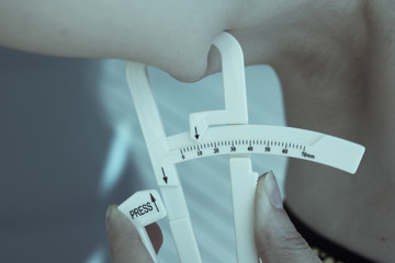 Woman measuring body contouring