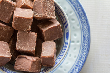 Chocolate Fudge in a Bowl From Above on White Wooden Table