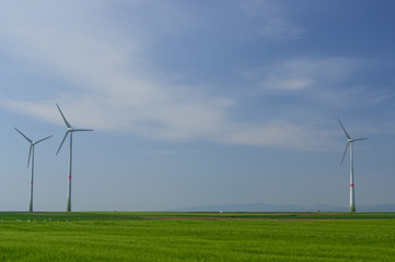 Fototapeta na wymiar meadow with Wind power turbines generating electricity