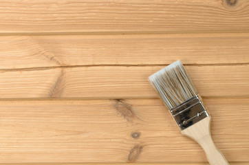Painting brush on wooden unpainted surfaces