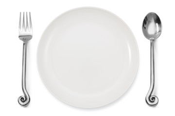 dinner place setting a white plate with silver fork and spoon