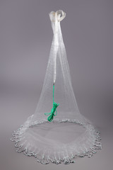 Harvest fishing tackle hand-cast nets on grey background