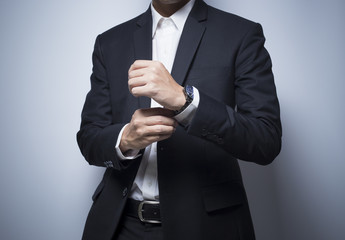 Businessman adjusting his cufflinks
