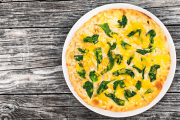 spinach cheese pie on white dish on wooden boards