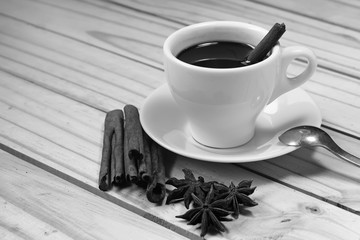 Glass of hot cinnamon espresso with effect back and white color.
