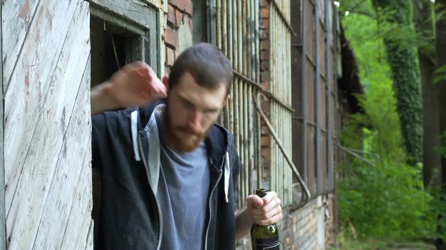 Man tasting wine while drinking it next to the abandoned building
