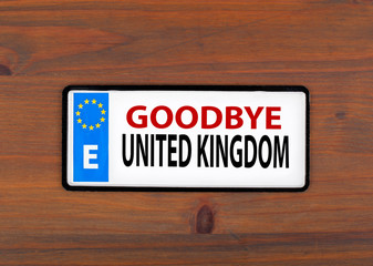 Goodbye United Kingdom. On a wooden board metal plate with europ