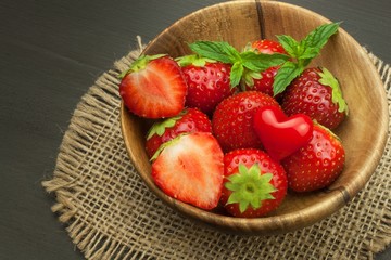 Strawberry on a wooden background. Advertising for the sale of fresh strawberries.
