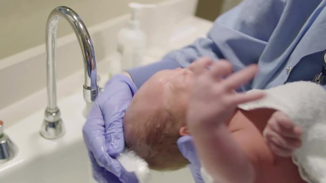 Newborn Baby gets Head Washed with Shampoo After Birth in Hospital