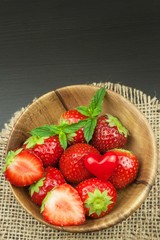 Strawberry on a wooden background. Advertising for the sale of fresh strawberries.
