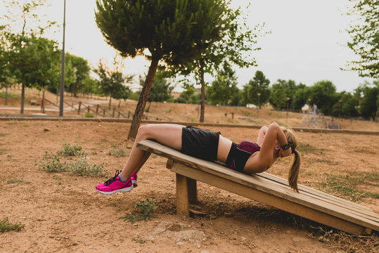 Fitness woman doing situps in park