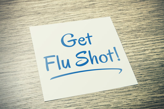 Get Flu Shot Reminder On Paper On Wooden Table