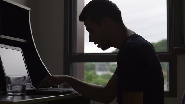 Mentally ill male using laptop super slowly, computer newbie, modern gadgets