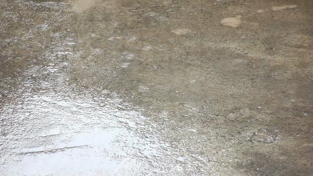 Raining Water Drops On Empty Cement Ground Footage