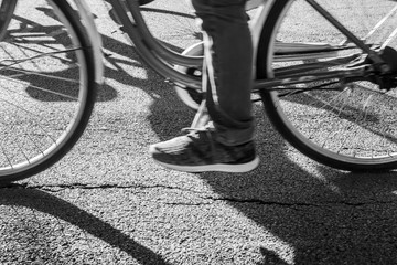 Fototapeta na wymiar Black and white bicycle against shadow on the street