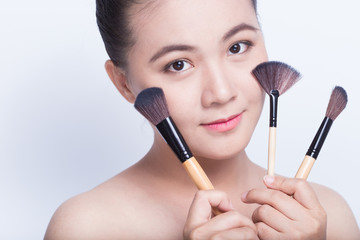 Beauty shot of woman holding the makeup brush