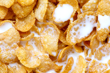 Background of cornflakes in milk from above.