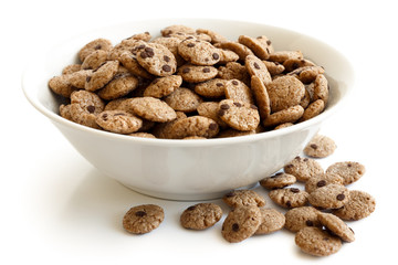 Bowl of chocolate chip cookies cereal isolated with spill.