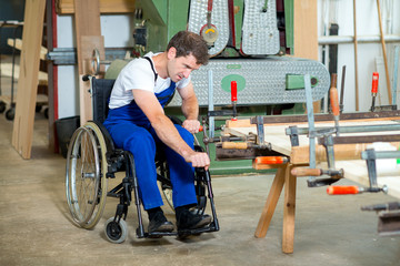 worker in wheelchair in a carpenter's workshop