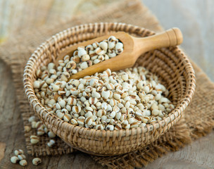 Millet the organic grain food in basket on wood table